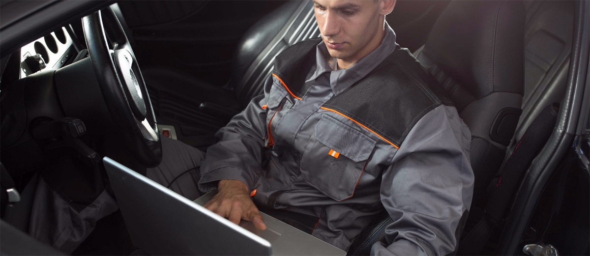 Mechanic checking a vehicle using a computer - ECU Remapping Bristol